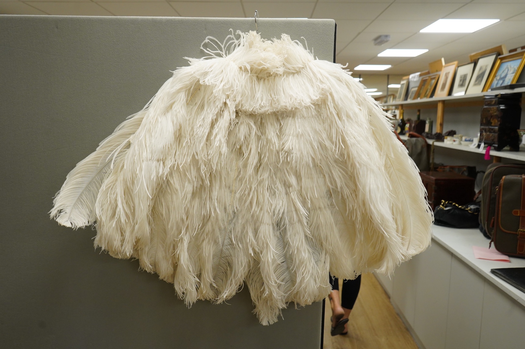 A 1930’s white Ostrich feather evening cape, with small feather stand up collar half lined in georgette.667cm long from top of collar to base. Condition - good - may need professional cleaning.